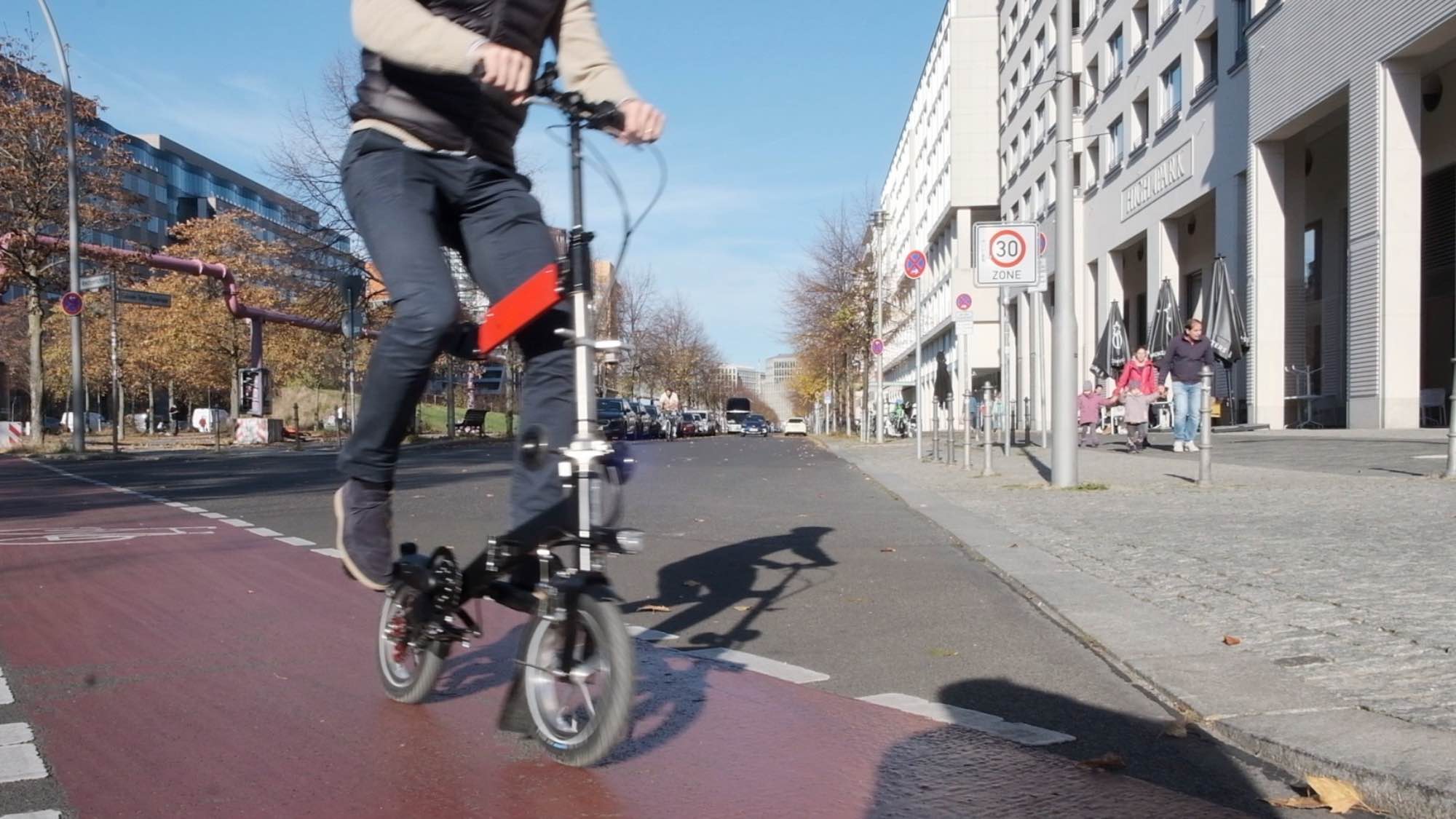 upride folding bike is ridden over bike path in Berlin. Quick ride. Upright posture.