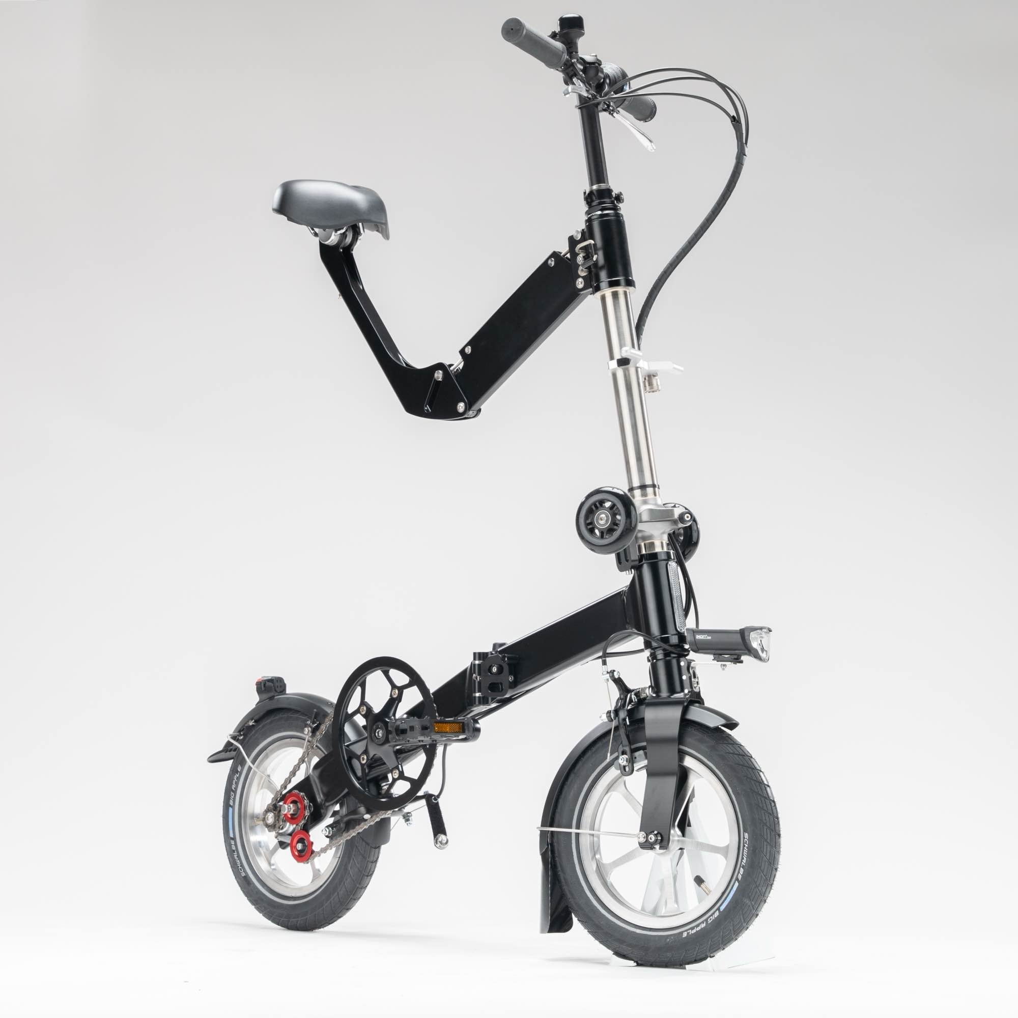 Black upride folding bike shown from the front, with mudguards, light, rack, and 3-speed transmission.
